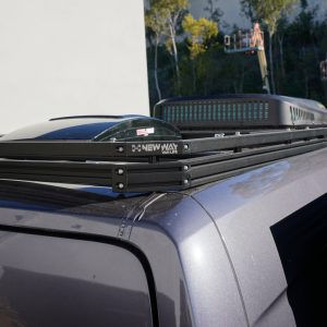 New Way Van Life aluminum roof rack installed on a 2022 Mercedes Sprinter van shown from the rear corner angle with MaxxFan vent and rooftop AC unit mounted on the platform