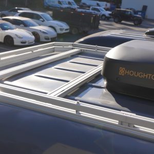 Silver aluminum roof rack installed on a 2025 Mercedes Sprinter van with a Houghton rooftop AC unit mounted on the platform shown from a close overhead angle
