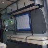 Van conversion overhead cabinet with lift-assisted doors inside a Mercedes Sprinter van build