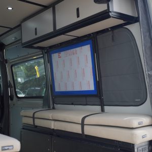 Van conversion overhead cabinet with lift-assisted doors inside a Mercedes Sprinter van build