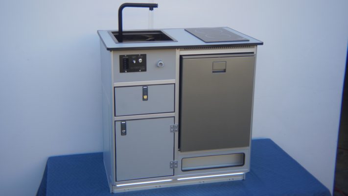 All-in-one self-contained camper van kitchen unit with sink, induction cooktop, fridge, and water system for Sprinter van conversion