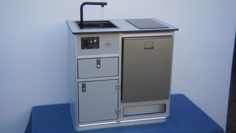 All-in-one self-contained camper van kitchen unit with sink, induction cooktop, fridge, and water system for Sprinter van conversion