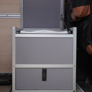 New Way Van Life Wrappon toilet cabinet with top lid open showing Wrappon toilet unit from the front inside a Mercedes Sprinter van conversion